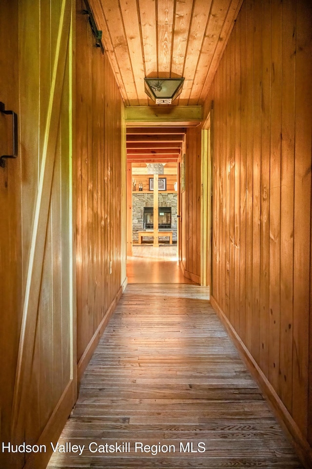 422 Waterview Dr, Andes, NY 13731 - corridor featuring wood ceiling, hardwood / wood-style floors, wood walls, and baseboards
