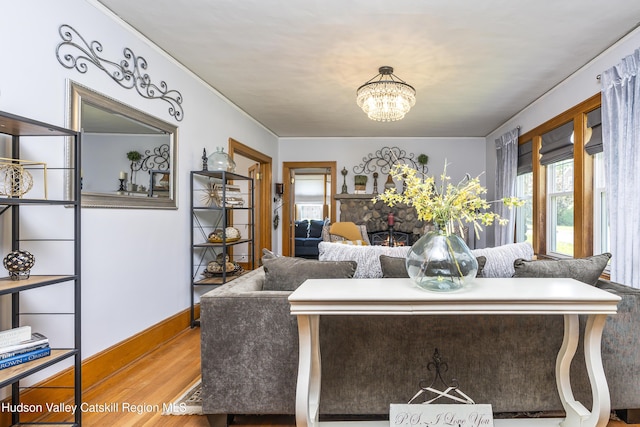 71 Melrose Ave, Albany, NY 12203 - living area featuring wood finished floors, a chandelier, and baseboards