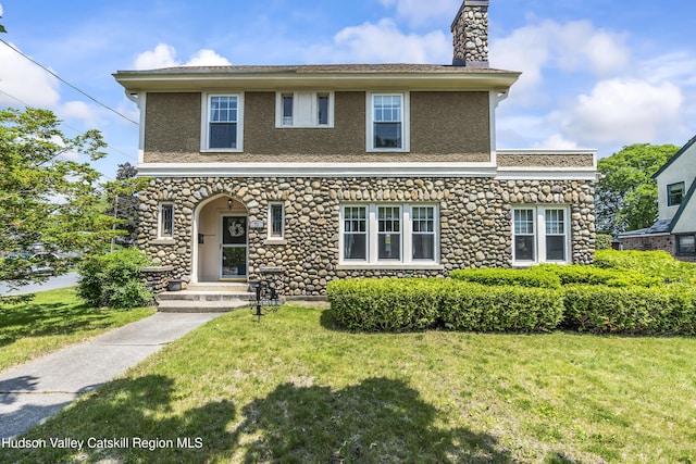 71 Melrose Ave, Albany, NY 12203 - view of front of home featuring a front lawn, a chimney, stone siding, and stucco siding