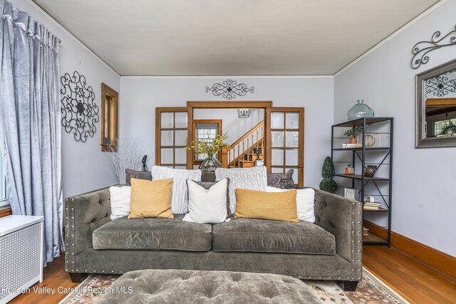 71 Melrose Ave, Albany, NY 12203 - living area featuring wood finished floors, crown molding, and radiator heating unit