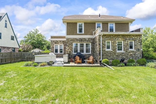 71 Melrose Ave, Albany, NY 12203 - back of house with stucco siding, stone siding, and a patio
