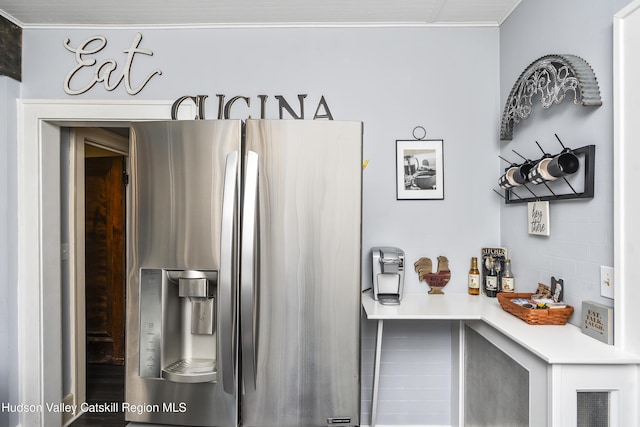 71 Melrose Ave, Albany, NY 12203 - detailed view of stainless steel fridge with ice dispenser, light countertops, ornamental molding, and backsplash