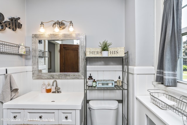 71 Melrose Ave, Albany, NY 12203 - bathroom featuring vanity, toilet, and wainscoting