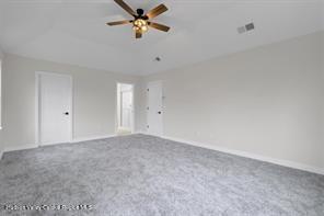 unfurnished room with ceiling fan and carpet floors