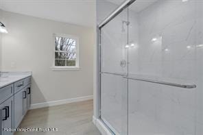 bathroom featuring vanity and a shower with shower door