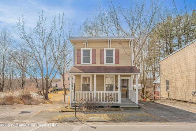 italianate-style house with covered porch and driveway