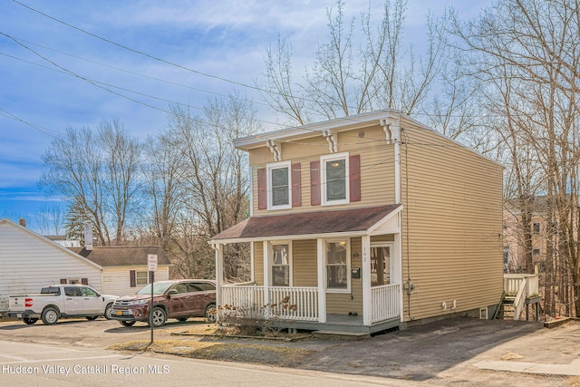 italianate house with a porch and uncovered parking