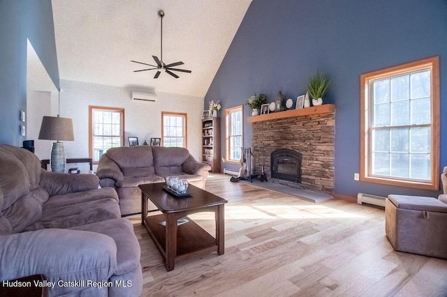 living room featuring light wood-type flooring, high vaulted ceiling, and a wealth of natural light