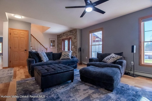 living room with wood-type flooring, a baseboard radiator, plenty of natural light, and ceiling fan