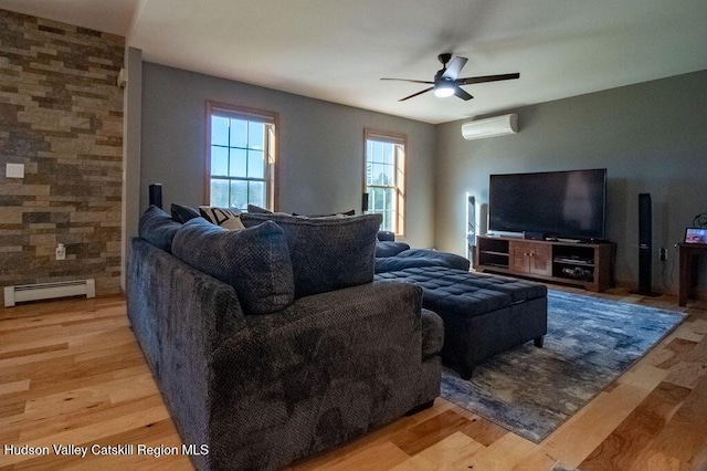 living room with a wall mounted AC, ceiling fan, a baseboard radiator, and light hardwood / wood-style floors