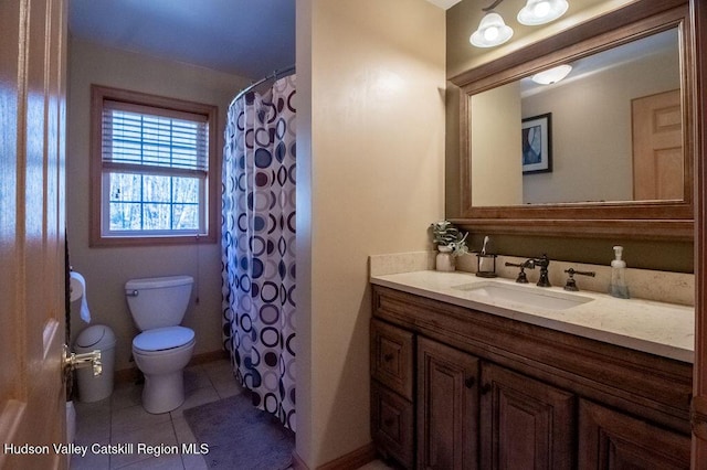 bathroom featuring toilet, vanity, tile patterned floors, and walk in shower