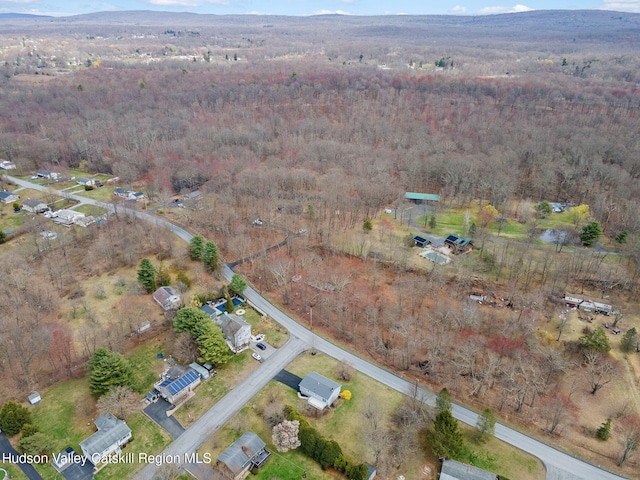 birds eye view of property featuring a view of trees