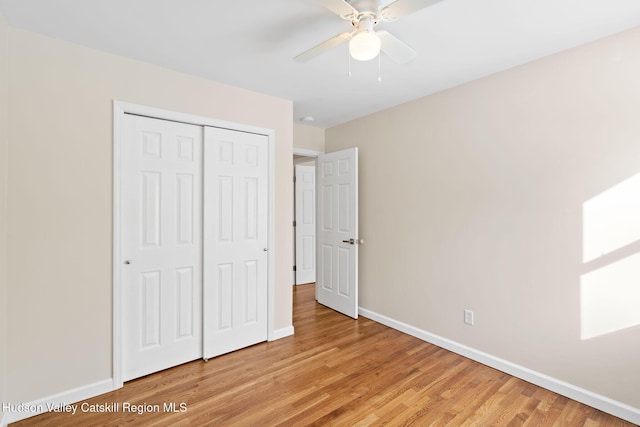 unfurnished bedroom featuring ceiling fan, a closet, and light hardwood / wood-style flooring