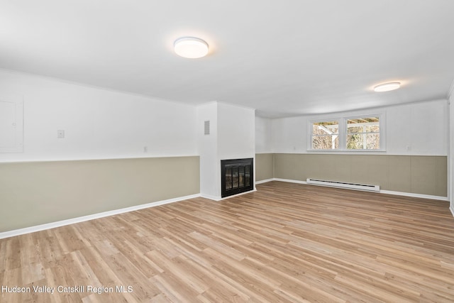 unfurnished living room with a baseboard radiator and light hardwood / wood-style flooring