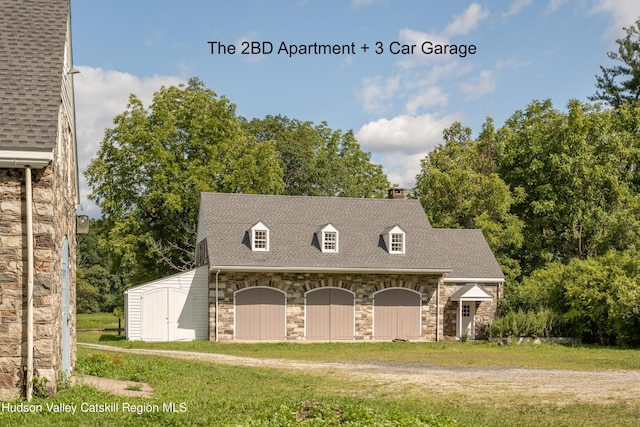 exterior space with a storage unit and a front lawn