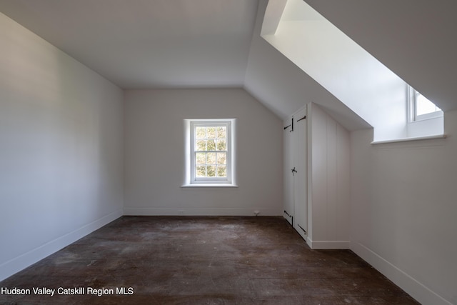 additional living space featuring lofted ceiling