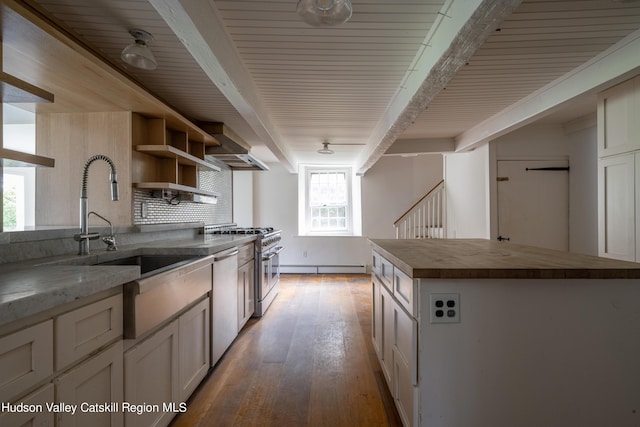 kitchen featuring stainless steel appliances, a baseboard heating unit, wall chimney range hood, hardwood / wood-style floors, and a kitchen island