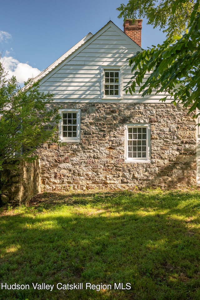 view of side of home featuring a lawn