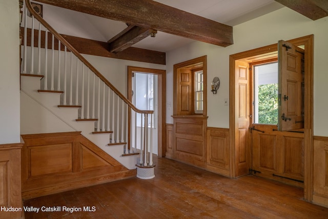 foyer featuring beamed ceiling and light wood-type flooring