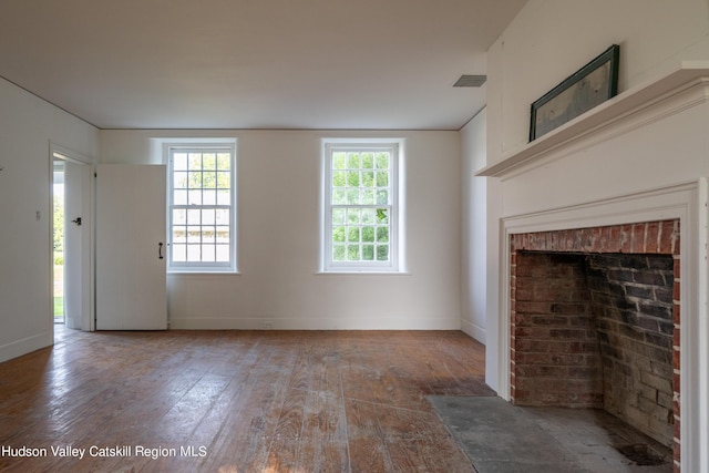 unfurnished living room featuring wood-type flooring