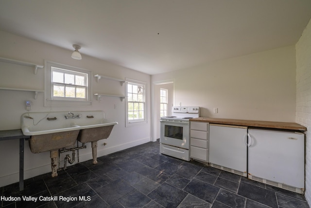 kitchen featuring white range with electric cooktop and sink