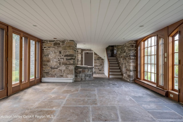 unfurnished sunroom with plenty of natural light and wood ceiling