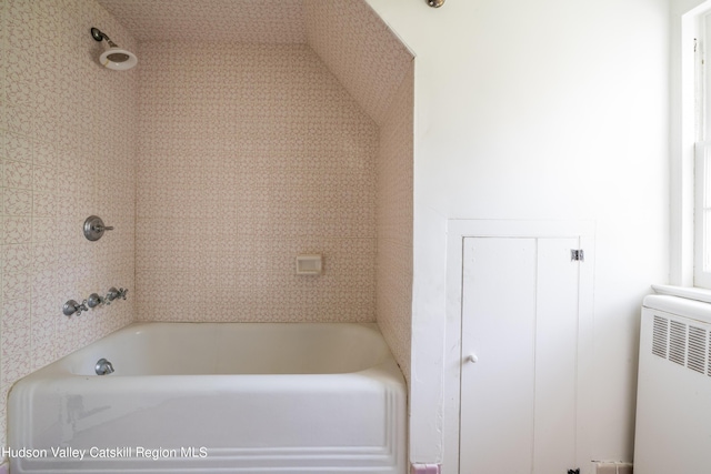 bathroom featuring a bathing tub and radiator heating unit