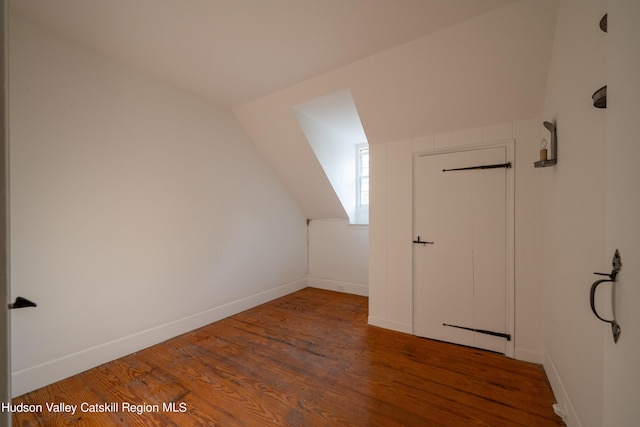 bonus room with dark hardwood / wood-style floors and lofted ceiling