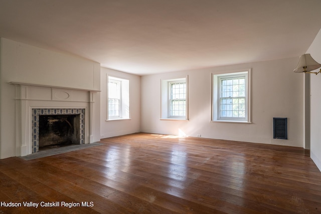 unfurnished living room featuring a fireplace and hardwood / wood-style floors