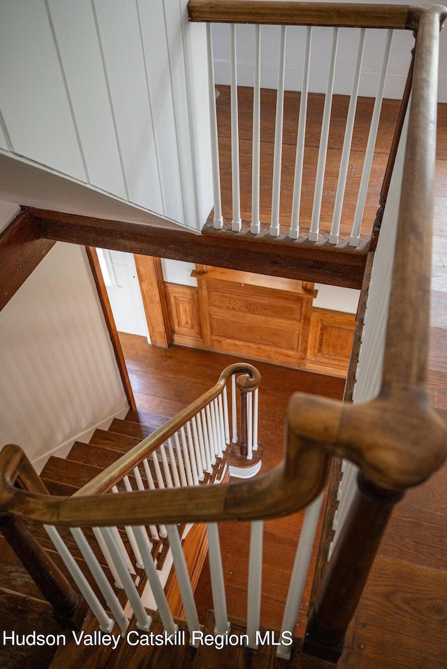 stairway featuring wood-type flooring