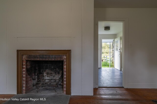 interior details featuring wood-type flooring and a fireplace