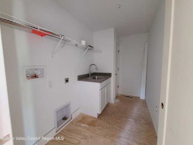 clothes washing area with washer hookup, electric dryer hookup, cabinets, and sink