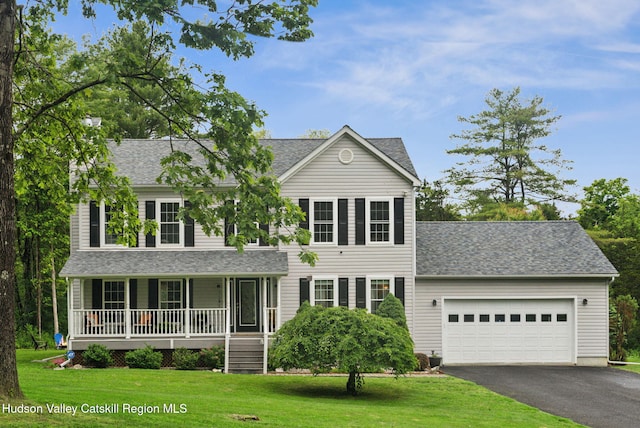 20 Cedar Ridge Rd, Stone Ridge, NY 12484 - view of front of house with covered porch, asphalt driveway, a garage, and a front lawn