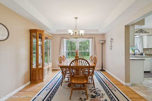 20 Cedar Ridge Rd, Stone Ridge, NY 12484 - dining area featuring a chandelier, a tray ceiling, and light wood-style flooring
