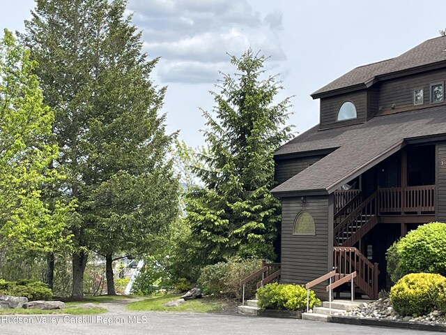 82 Liftside Dr Unit A13, Hunter, NY 12442 - view of side of home featuring a shingled roof and stairway