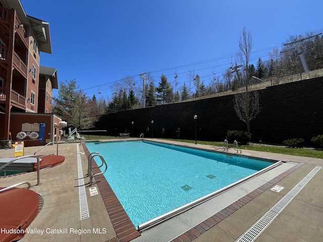 82 Liftside Dr Unit A13, Hunter, NY 12442 - community pool with a fenced backyard and a patio area
