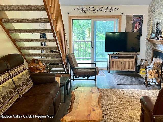 82 Liftside Dr Unit A13, Hunter, NY 12442 - living area with wood finished floors, stairs, and a stone fireplace