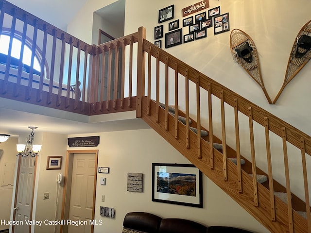 82 Liftside Dr Unit A13, Hunter, NY 12442 - stairway featuring a high ceiling and a chandelier