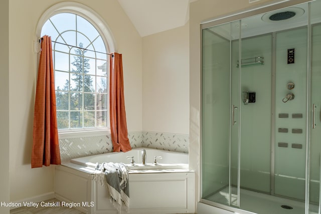 bathroom featuring separate shower and tub and vaulted ceiling