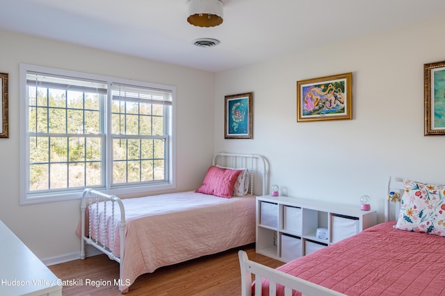 bedroom with wood-type flooring