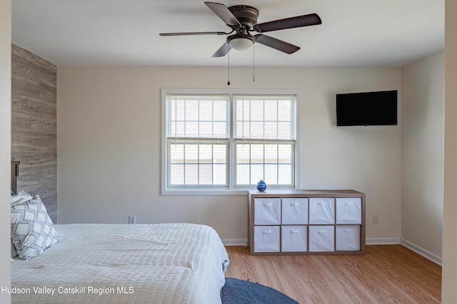 bedroom with light hardwood / wood-style floors and ceiling fan