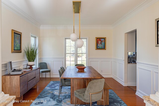 dining room featuring dark hardwood / wood-style flooring and crown molding