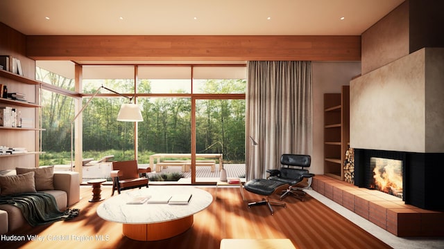 living room with hardwood / wood-style floors and a tiled fireplace