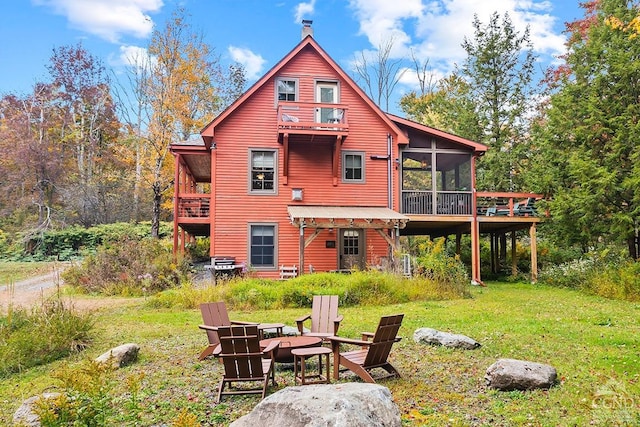 214 Fog Hill Rd, Austerlitz, NY 12017 - back of house featuring a sunroom, an outdoor fire pit, a balcony, and a lawn