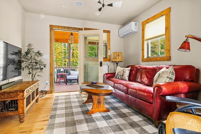 214 Fog Hill Rd, Austerlitz, NY 12017 - living room featuring a wall mounted air conditioner, plenty of natural light, wood finished floors, and a ceiling fan