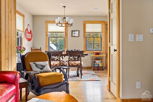 214 Fog Hill Rd, Austerlitz, NY 12017 - living area with wood finished floors, a chandelier, and baseboards