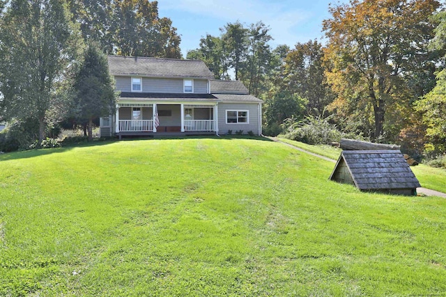 view of front of property with covered porch and a front lawn