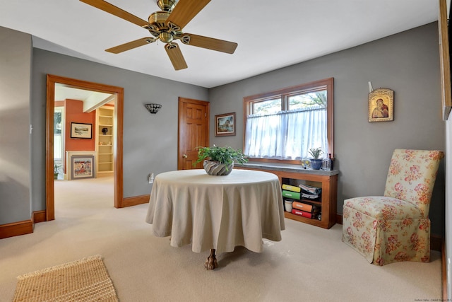 dining area featuring light colored carpet and ceiling fan