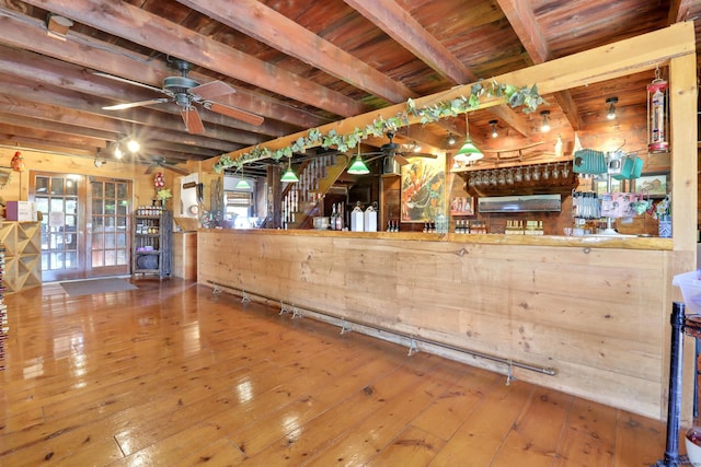 bar featuring wooden ceiling, hanging light fixtures, beamed ceiling, and wood-type flooring