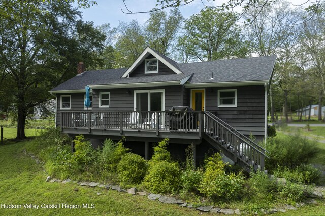 back of property featuring a wooden deck